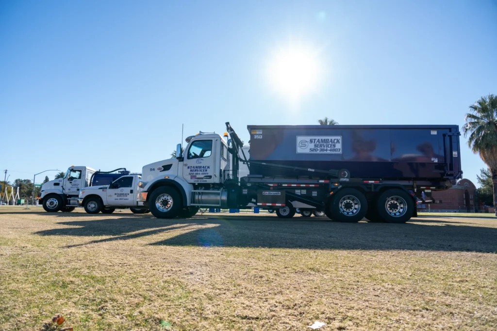 Stamback Services' trucks in a field on a sunny day