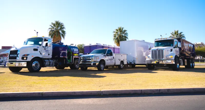 Stamback Services trucks lined up on a field.