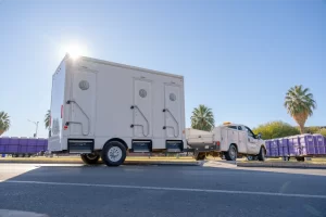 Stamback Services truck towing a VIP restroom trailer
